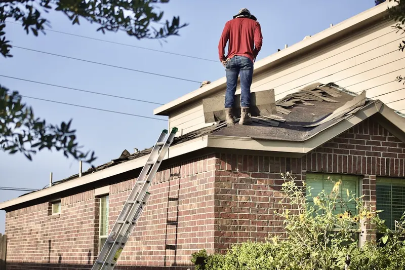 Professional roofer working on a residential roof in Rogers